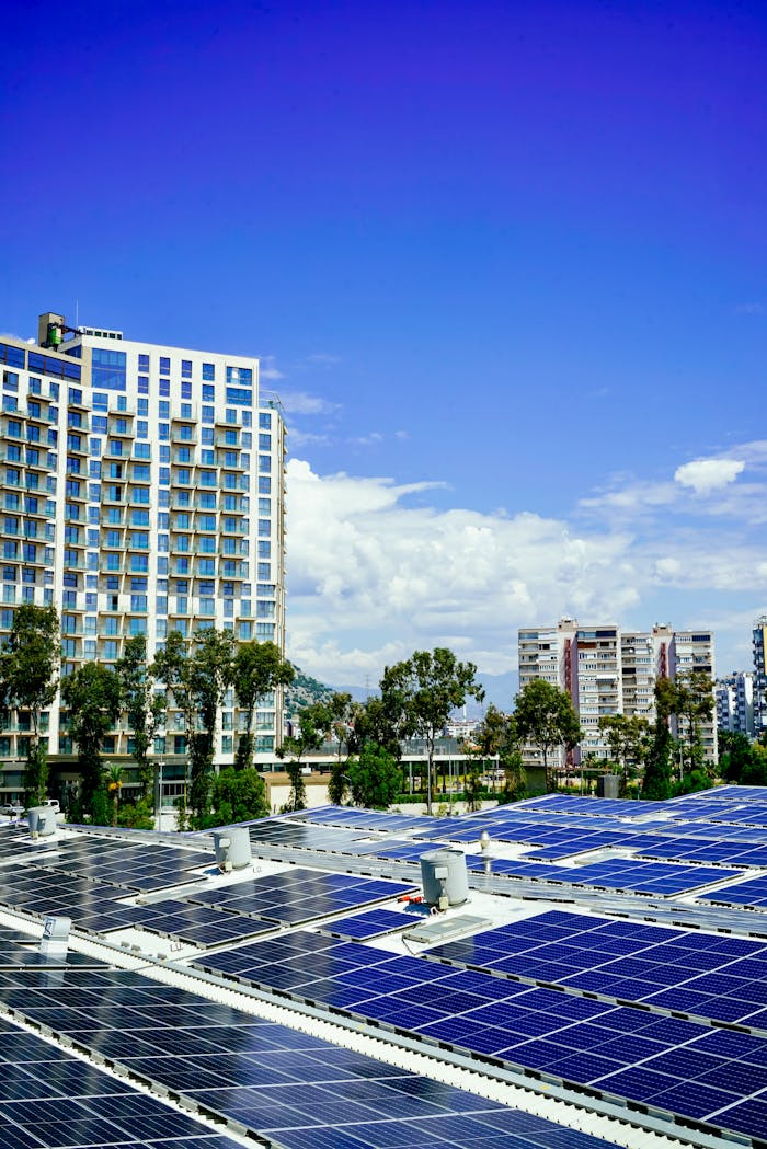 High-rise buildings and a large solar panel array under a clear blue sky.